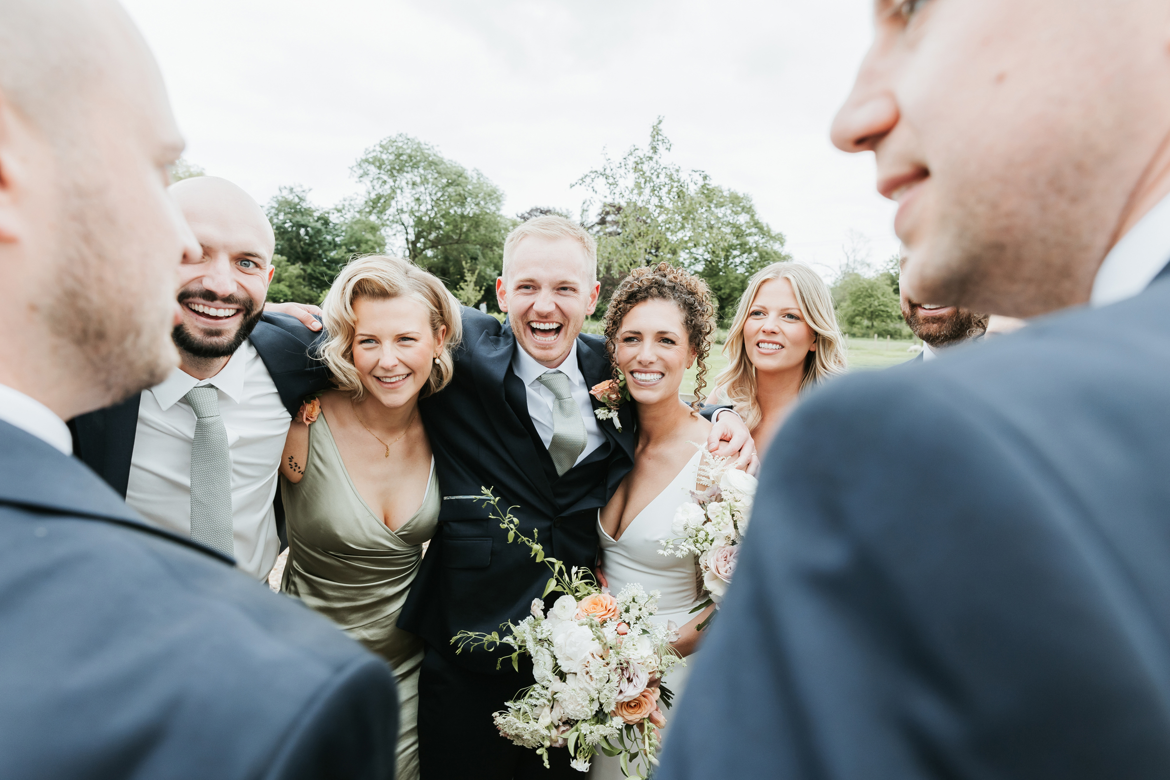 Natural wedding photography capturing guests dancing at evening reception.